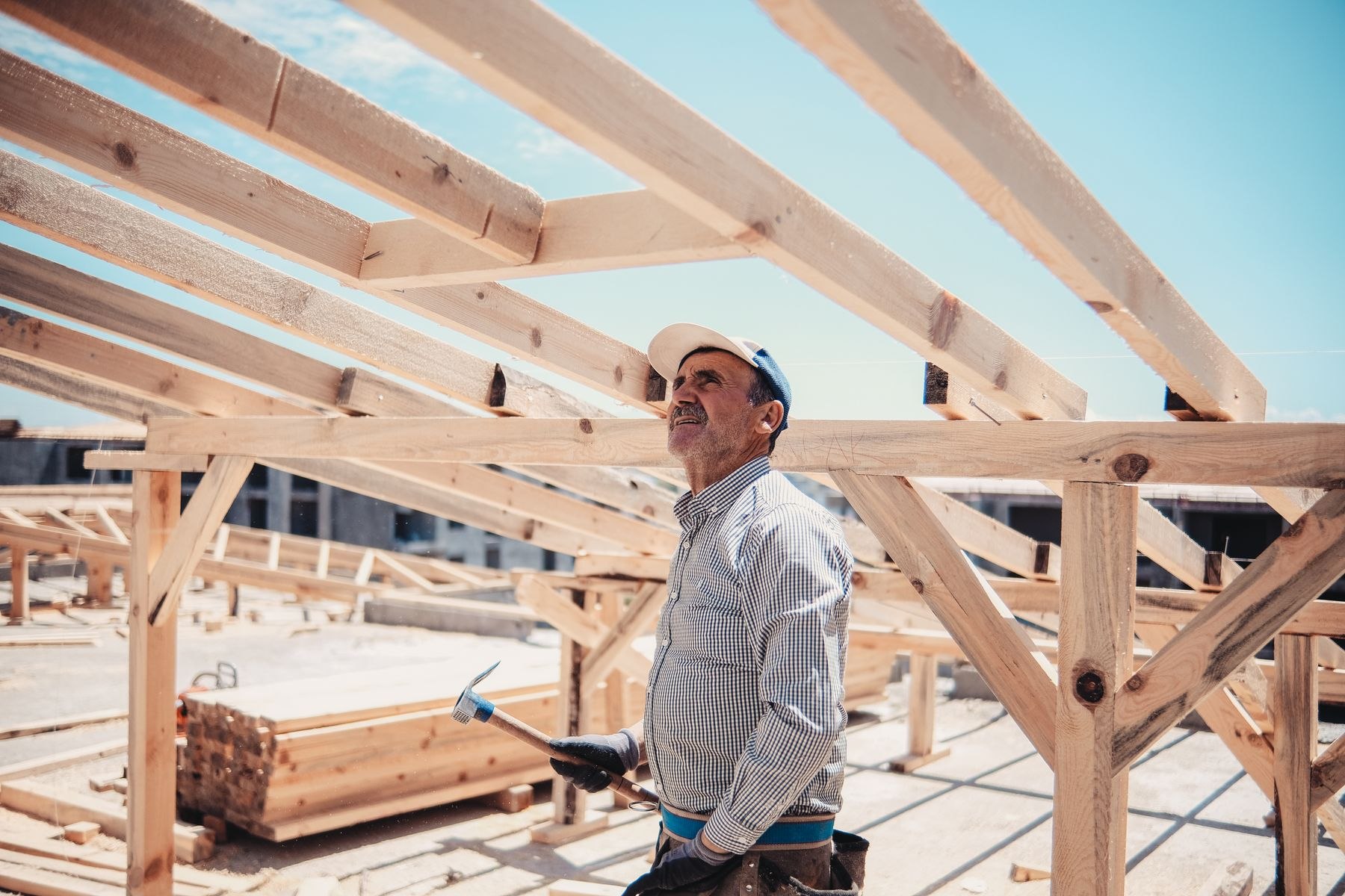 A builder inspecting a timber frame on site