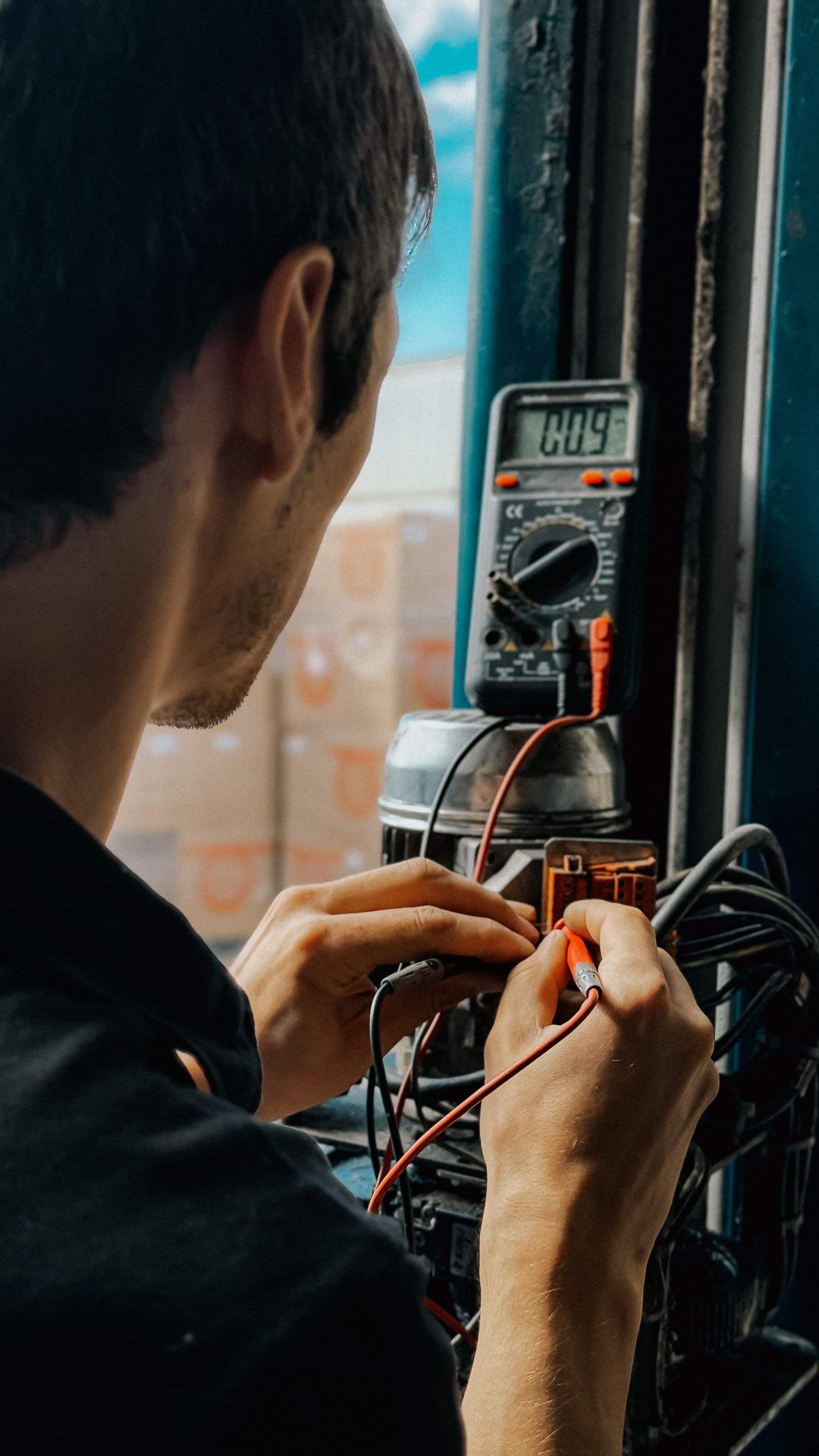 An electrician testing a circuit with a multimeter