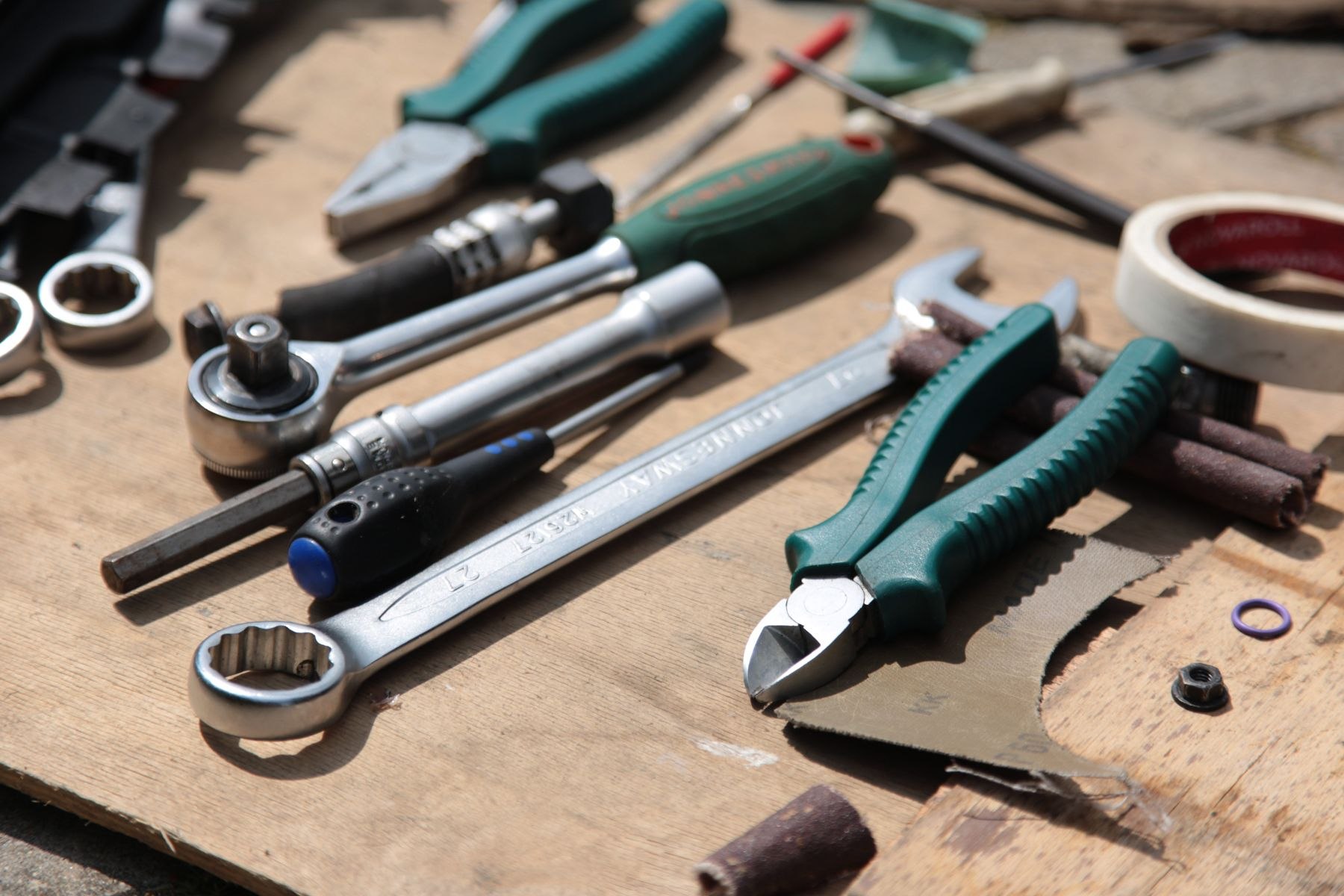 A flatlay of hand tools on a workbench